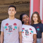 Three models posing in all three colors of LA tee