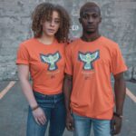 Woman and man wearing Worthy of Change orange t-shirts